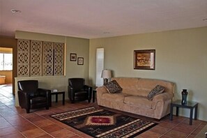 Your living room with flat screen TV and pull out sofa for extra sleeping
