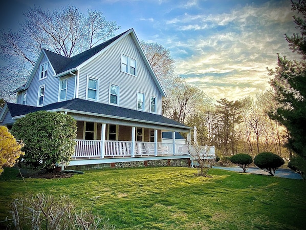 Over a half acre of privacy, a wrap-around covered porch, and large open deck