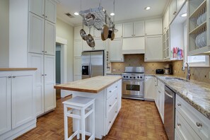 Kitchen w/ "commercial style" gas range, stainless refrigerator & dishwasher.