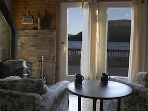 By woodstove looking out over water