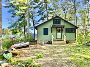 Cottage with two kayaks and swim float getting ready for the water.