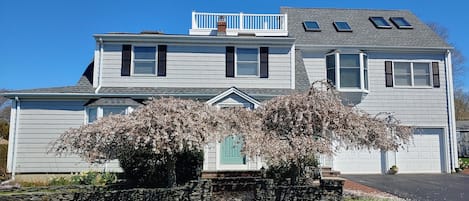 Front with main house on left, in law apt on right above garage with roof-deck