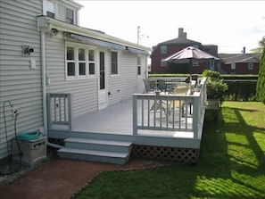 Large deck off main house with dual awnings,  private backyard