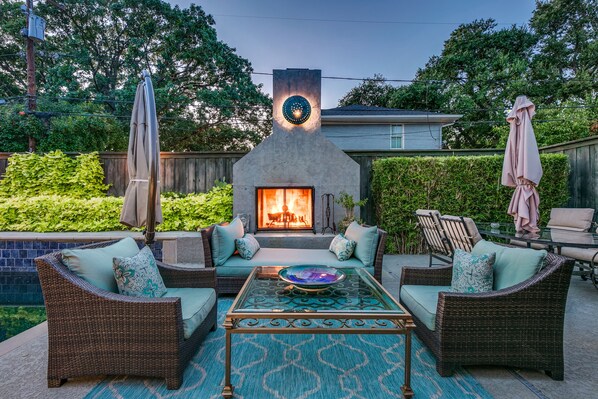 Relaxing poolside wood-burning fireplace 