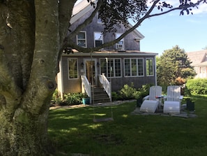 Front Of home shaded by large front yard tree afternoon 