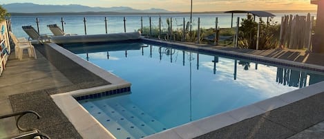 Solar heated pool with glass enclosure for spectacular views while swimming.