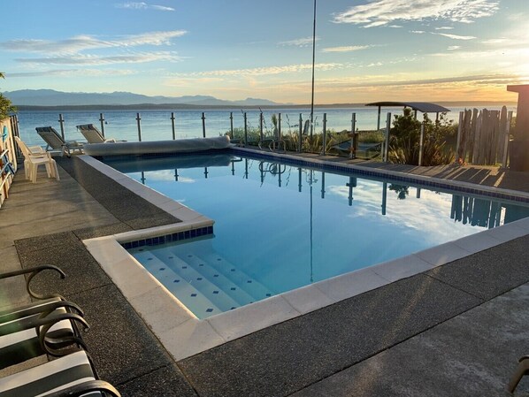 Solar heated pool with glass enclosure for spectacular views while swimming.