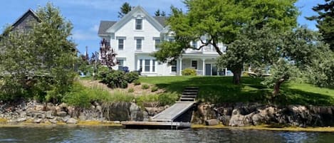 View of the house, backyard and private dock taken from the water