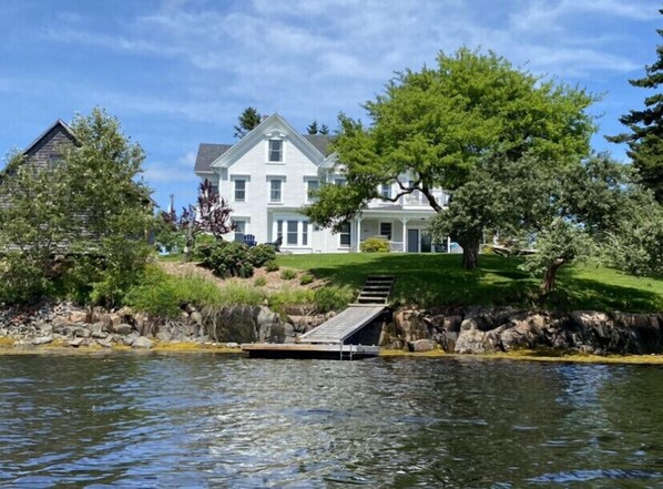 View of the house, backyard and private dock taken from the water