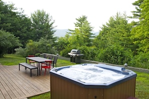Hot tub, grill, and outdoor dining space