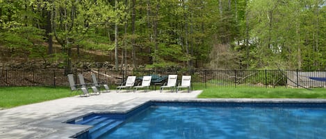 Pool with deck chairs  