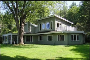 back of house with windows onto mountain view