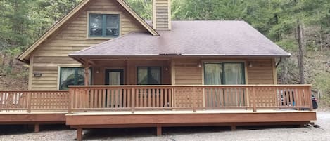 Outdoor area with patio dining set, propane grill and fire pit with two benches.