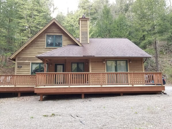 Outdoor area with patio dining set, propane grill and fire pit with two benches.