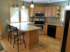 Kitchen with fridge, oven, dishwasher, microwave, coffee maker, blender, toaster