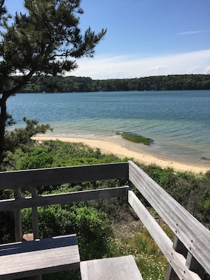 View of the water and sandy beach from the deck.