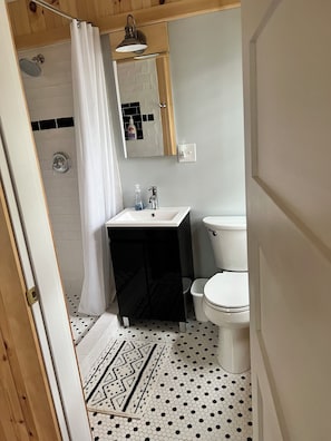 Upstairs master bedroom’s bathroom with a shower.