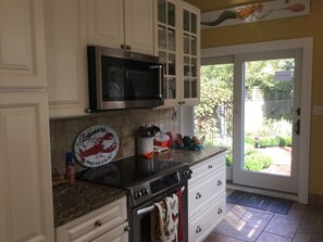 Fully equipped kitchen overlooking herb garden