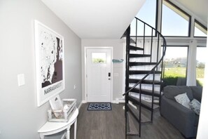 Living room (with stairs leading up to 2 bedrooms and a full bathroom)