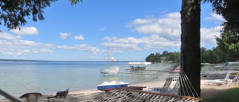 Shaded hammock overlooking sparkling Burt Lake and our sandy beach