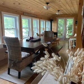 Front porch has dining  table for eating and playing games with a view. 