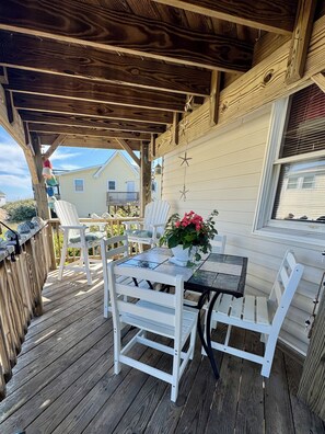 Cozy shaded deck off kitchen - table & counter chairs with terrific ocean views.