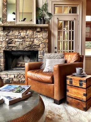 Detail of luxurious open concept den with woodburning fireplace