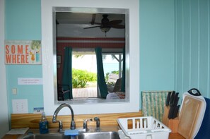 Kitchen opening frames the beach and ocean.