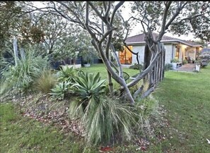 Front yard with sprawling lawn to relax in. Lie in Hammock under tree. 