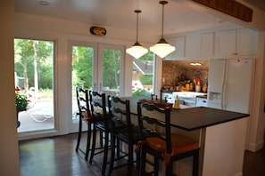 Large open kitchen. Chefs have 360 view of living room, dinning room and pool