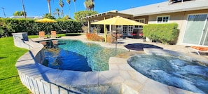 Pool has raised wall with water feature for privacy