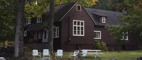 Front of house with fire pit in foreground 