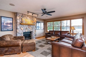 Large family room overlooking the lake with a field stone gas fireplace.