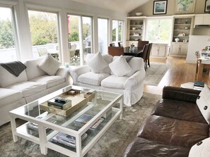 Open living room with water and sunset views