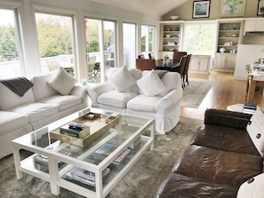 Open living room with water and sunset views