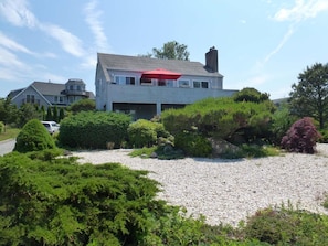 Beachy house with upper and lower deck facing water