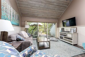 Beautiful living room looking out towards the Crystal River and woods beyond.
