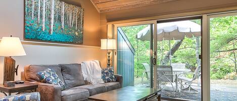 Lovely view from the living room of the woods beyond the patio.