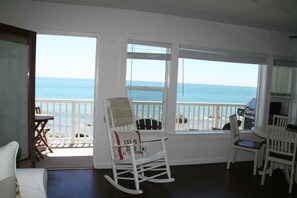 Cozy dining area off living room with coastline view