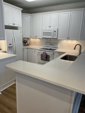 full updated kitchen with tile backsplash