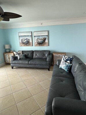 Den area is inviting with the warm colors of blues, gray and taupe. 