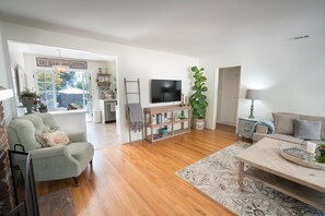 Comfortable living room with fireplace, Smart TV and sleeper couch
