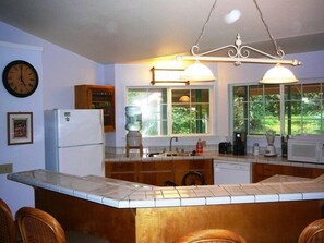 Fully equipped kitchen with additional seating at the bar.