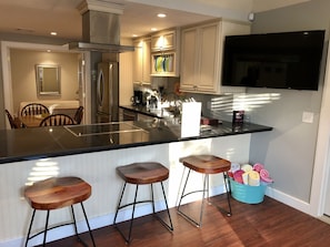 kitchen with table and bar stolls