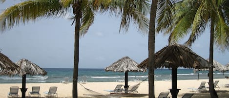 Enjoy the Caribbean sun or relax in the shade on our beautiful white sand beach