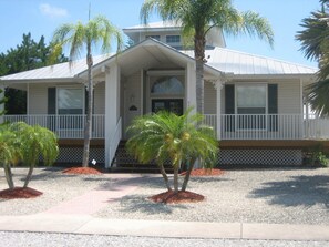 Front of house with wrap around deck.