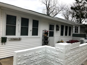 Front of our cottage - sidewalk to the beach is on the left