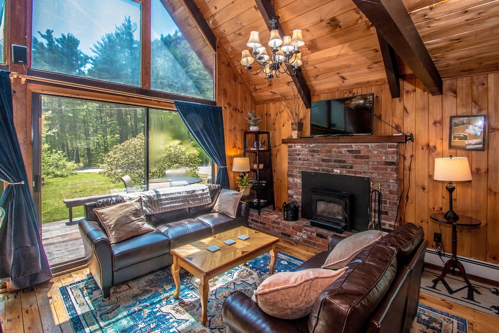 Tall windows show a beautiful view at a North Conway vacation rental