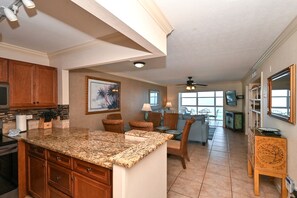 Spacious living room with view out to Lanai, the beach and azure waters of the Gulf of Mexico...large HDTV, stereo, and more...