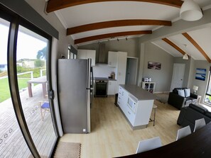 Very sociable large living space with kitchen, comfy seating and dining area. 